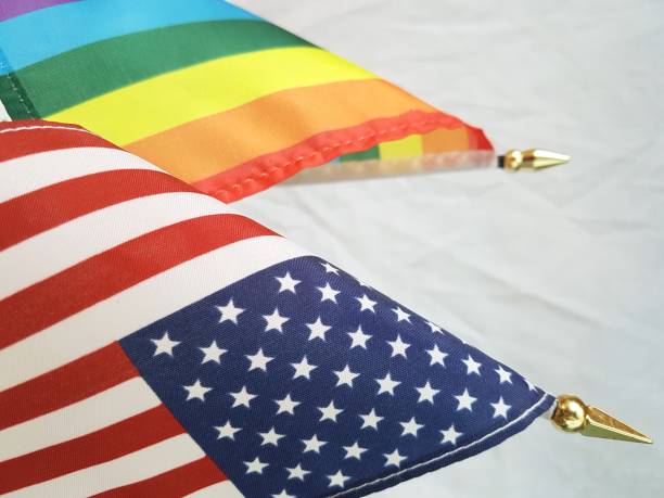 istock USA and LGBT+ rainbow flags together (vertical) 1153111673