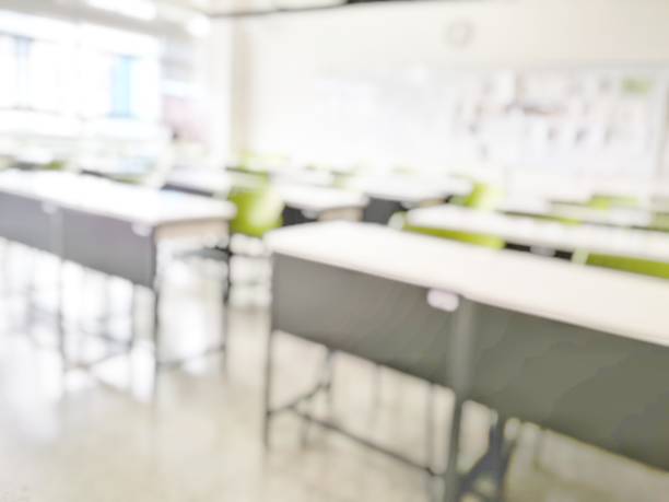 istock School classroom in blur background without young student; Blurry view of elementary class room no kid or teacher with chairs and tables in campus. 1153114908