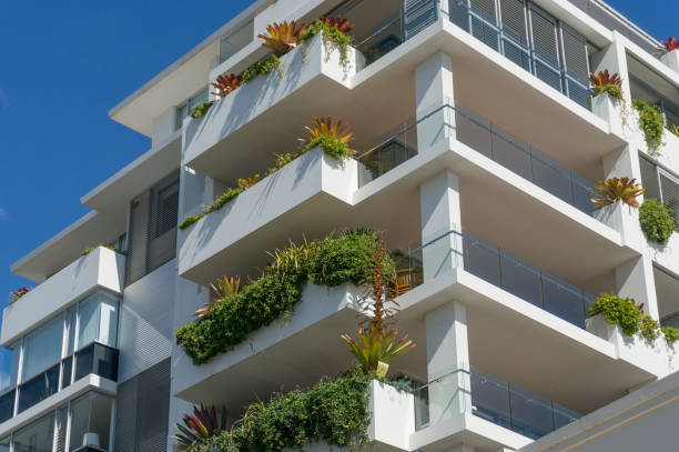istock White building with green plants on balconies 1153114984