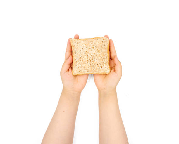 istock Female hand holding Sliced bread on a white background 1153119000