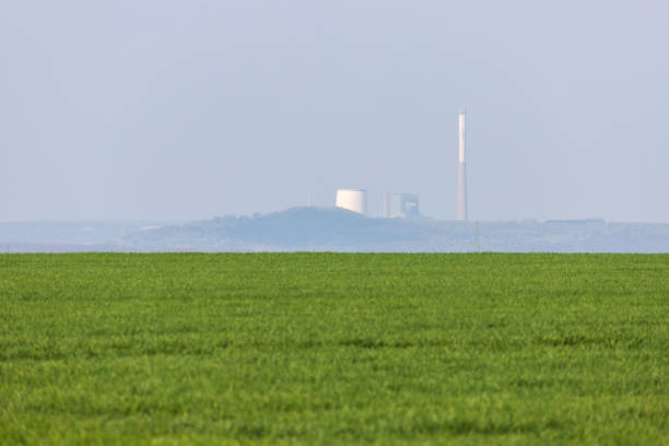istock a plain meadow in front of a power plant 1153122247
