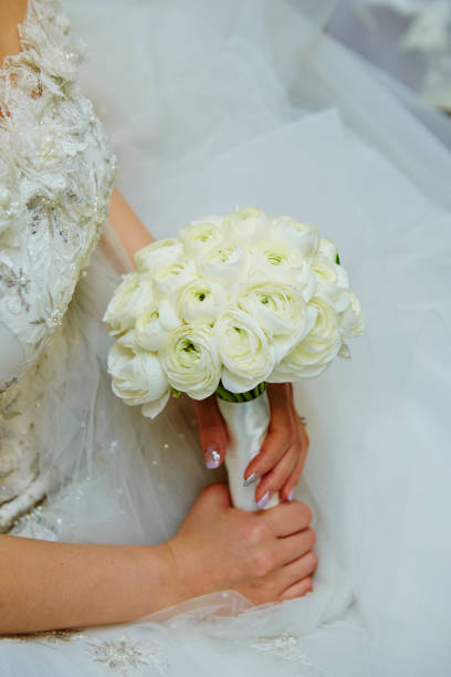 istock Bride holding flower bouquet 1153132126