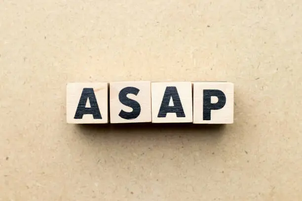 Photo of Alphabet letter block in word ASAP (Abbreviation of as soon as possible) on wood background