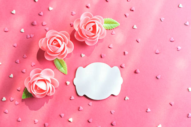 istock Pink background with pastry flowers and confetti 1153146683