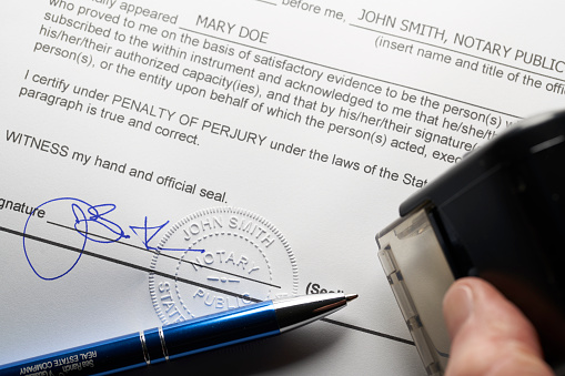 Notary Public: Seal embossed on document with pen