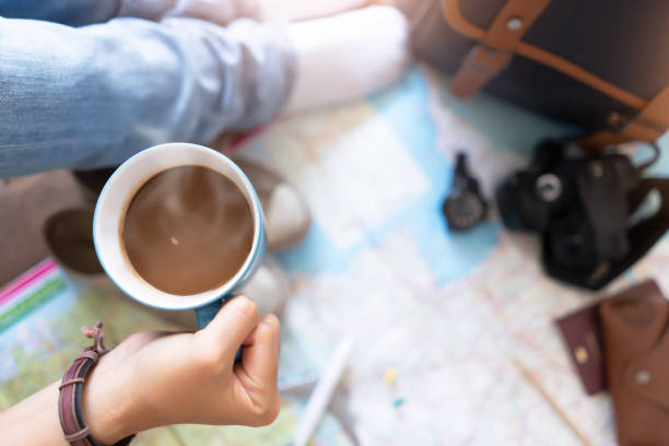 istock Hand hold coffee and planning for travel 1153147644