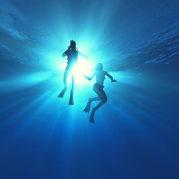 istock Low angle view of two scuba divers in the ocean. This is a 3d render illustration. 1153147747