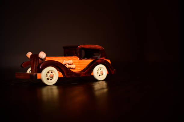 istock wooden toy car with black background 1153148801