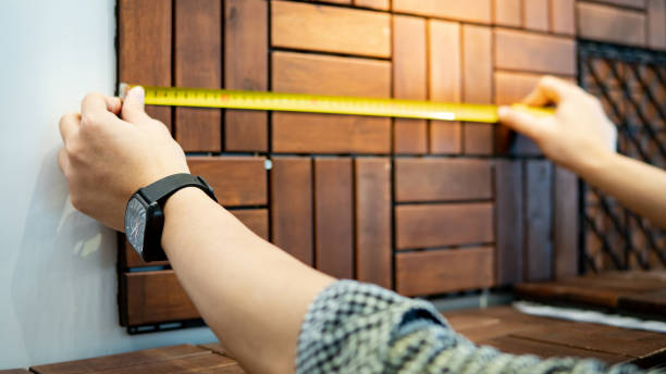 istock Male hand using tape measure on floor pavement 1153151748