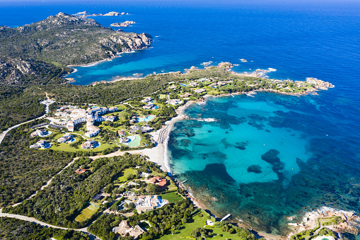 View from above, stunning aerial view of the Romazzino Beach bathed by a beautiful turquoise sea. Sardinia (Emerald Coast) Sardinia, Italy.