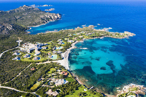 View from above, stunning aerial view of the Romazzino Beach bathed by a beautiful turquoise sea. Costa Smeralda (Emerald Coast) Sardinia, Italy.