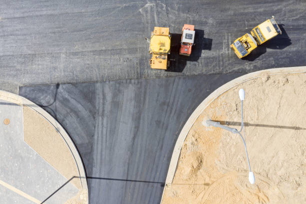 istock road rollers leveling asphalt on road. aerial top view 1153153607