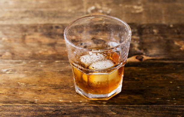 istock Whiskey and copyspace on wooden background 1153161054