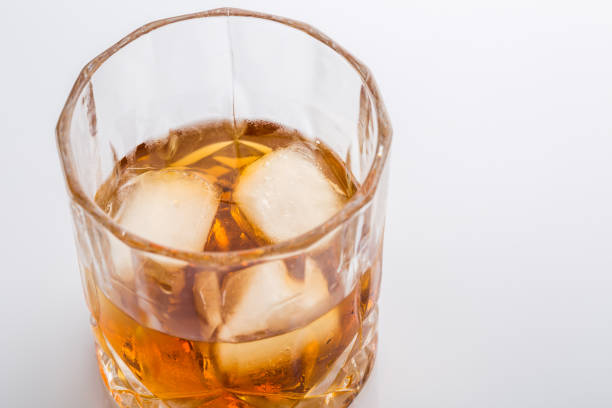 istock Glass of scotch whiskey on white background 1153161083