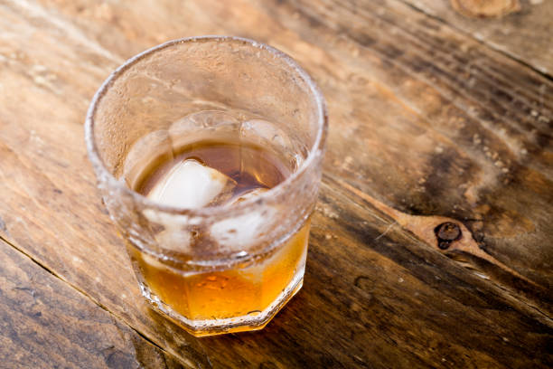 istock Whiskey and copyspace on wooden background 1153161084