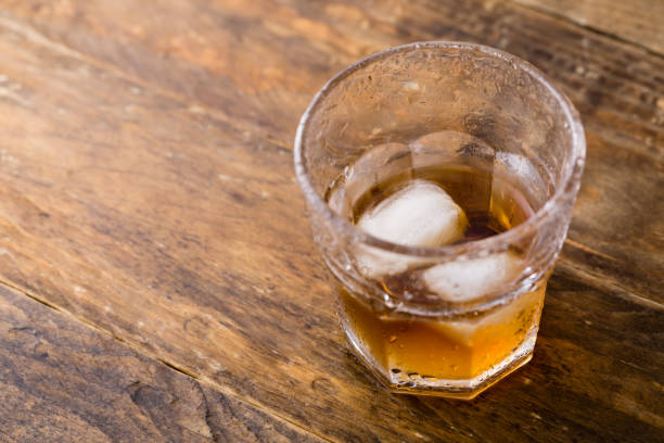 istock Whiskey and copyspace on wooden background 1153161116