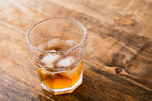 istock Whiskey and copyspace on wooden background 1153161146