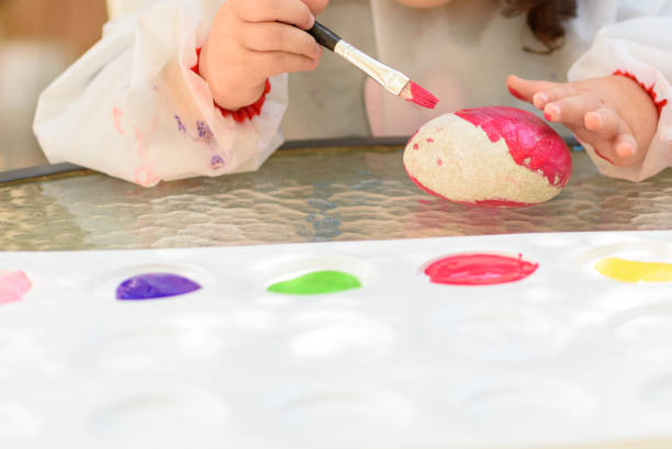 istock Little Child Drawing On Stone Outdoors On Summer Sunny Day. 1153162397