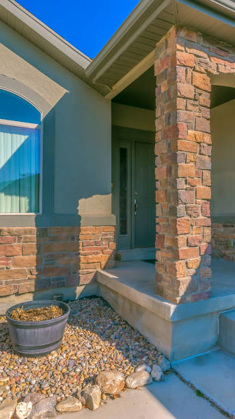istock Vertical frame Facade of a home with a rocky yard and small front porch 1153164688