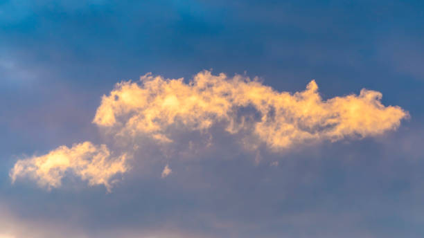 istock Panorama Puffy clouds illuminated by sunlight in the boundless blue sky 1153164721