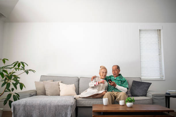 istock Senior Japanese Woman Explaining Smart Phone to Her Husband 1153165833