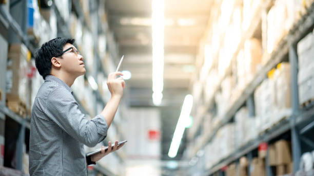 istock Asian man doing stocktaking on tablet in warehouse 1153165874
