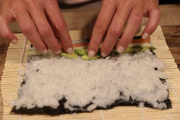 istock Woman preparing sushi in the kitchen 1153167009