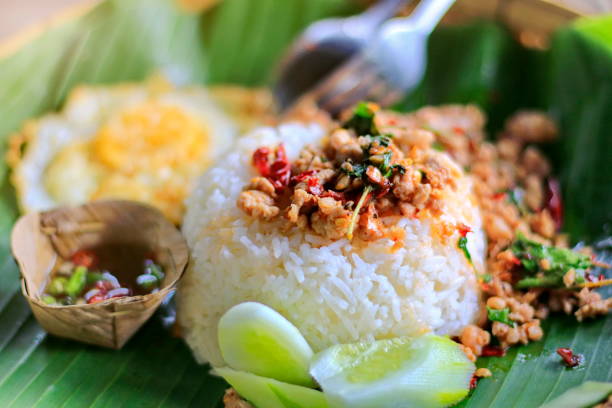 istock Fried Stir Basil with Minced pork On banana leaves with nature. 1153167149