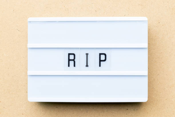 istock White lightbox with word RIP (abbreviation of rest in peace) on wood background 1153168475