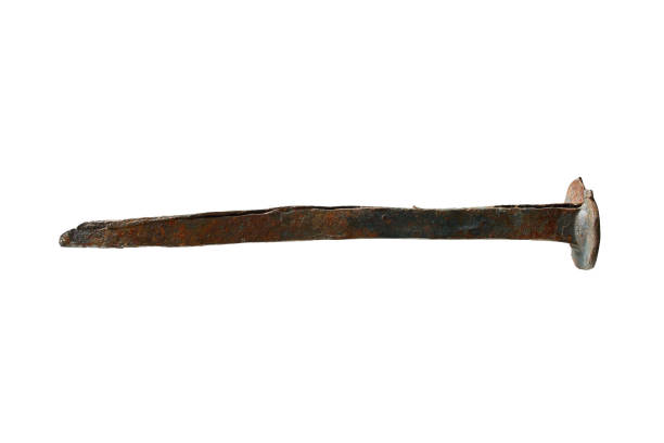 old, rusty, forged nail on a white background. insulated nail