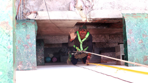 istock Piped Natural Gas (PNG) connection by hanging young men at residential building 1153170010