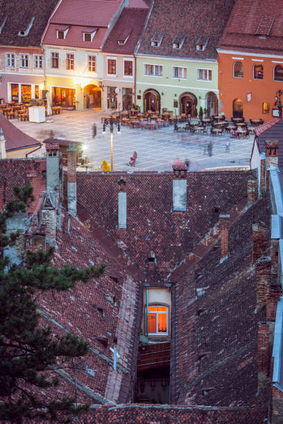 Lone window and Council Square in Brasov. \nBrasov, Brasov County, Romania.