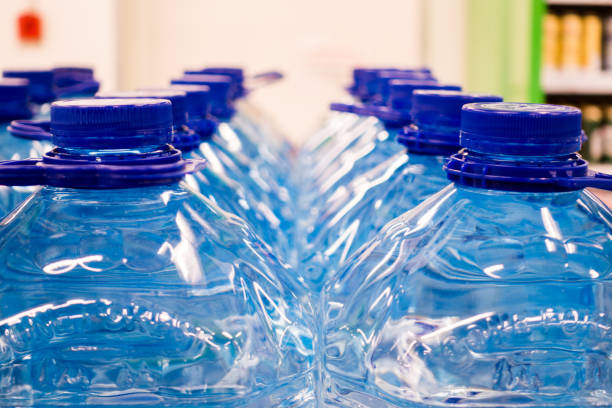 istock Lid plastic water bottle in the market. multi-colored plastic bottle caps 1153172603
