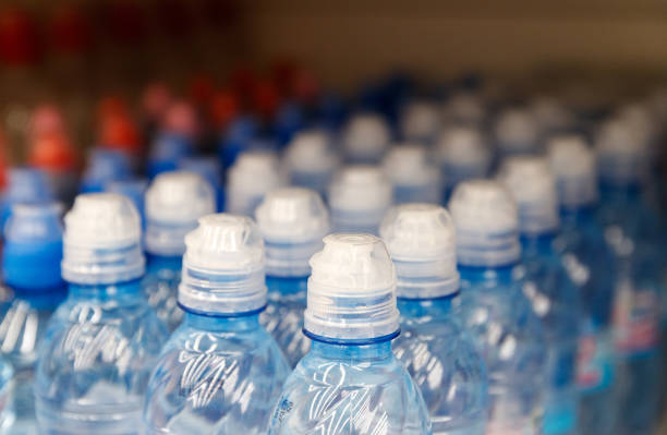 istock Lid plastic water bottle in the market. multi-colored plastic bottle caps 1153172605