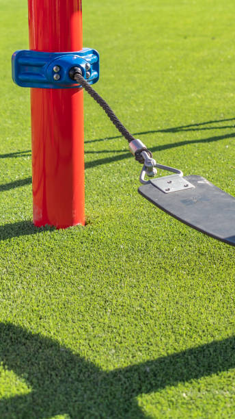 istock Vertical frame Play area with a seat supported by ropes that are connected to red poles 1153173135