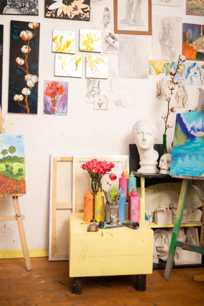istock Paints standing on little drawer near drawing easels 1153173758