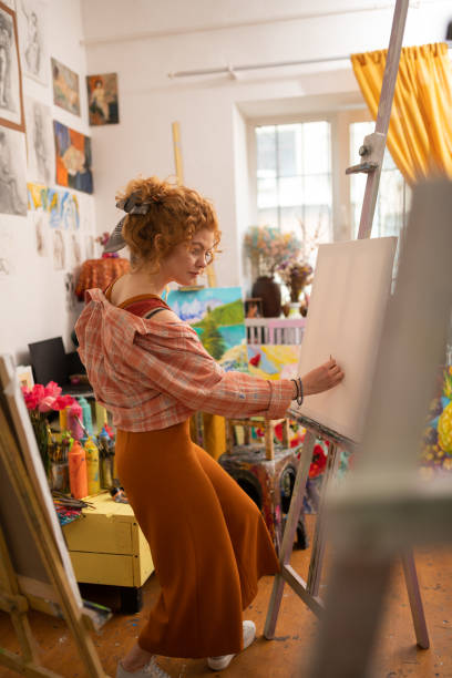 istock Curly young artist drawing at the weekend feeling relaxed 1153173828