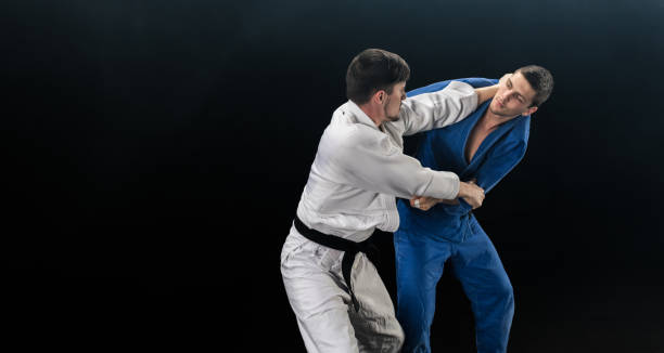 istock Male Judo Players Competing During Match 1153174301