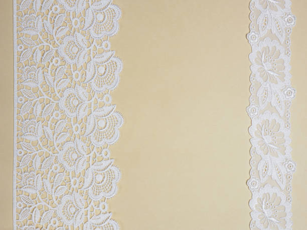 istock White laces on a beige background vertically in two row 1153177053