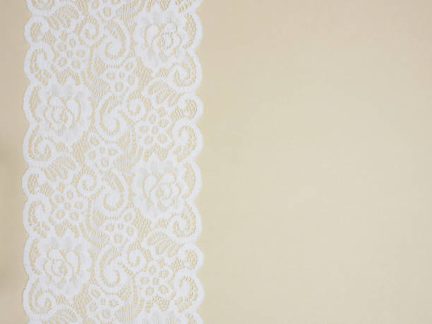 istock White laces on a beige background vertically in row 1153177579