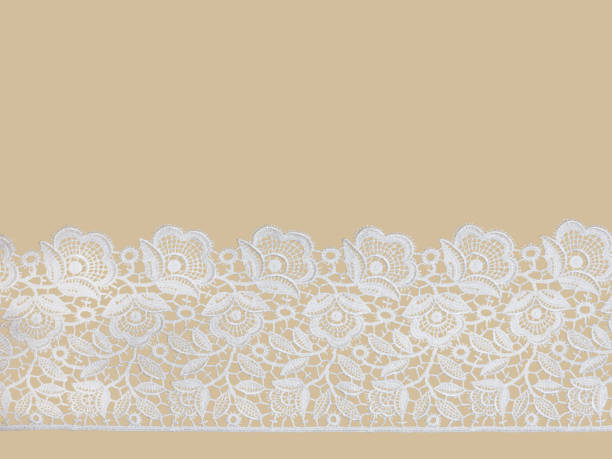 istock White laces on a beige background horizontally in row 1153177615
