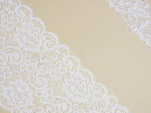 istock White laces on a beige background diagonally in two row 1153177627