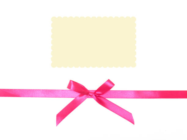 istock Pink satin ribbon bow with ivory record place on white background 1153178238