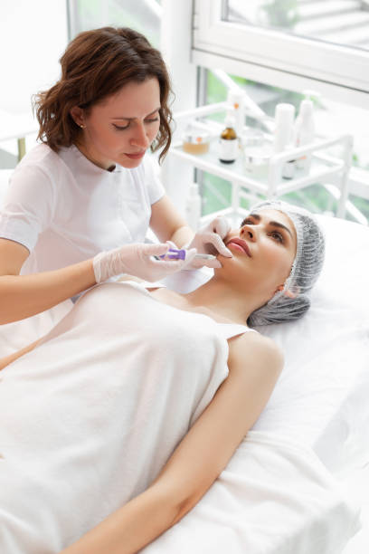 istock Serious hard working cosmetologist doing beauty injections 1153179534