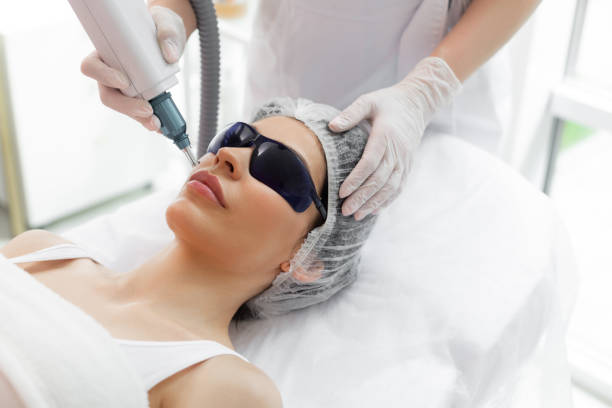 Nice pretty woman receiving laser skin treatment stock photo