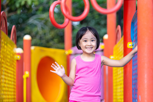 Asian Chinese little girl playing at outdoor playground alone