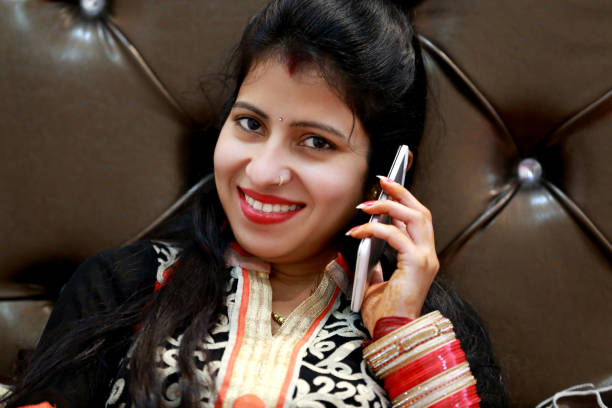 istock Cheerful young women talking on mobile phone 1153184224