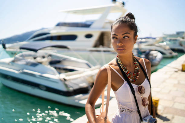 Beautiful asian woman standing at harbor.