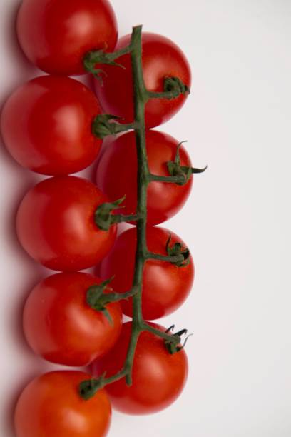 istock Cherry tomato bunch closeup isolated on white background. 1153193175