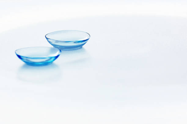 Contact lenses on light blue background Eyewear, eyesight, eye care and health, ophthalmology and optometry concept. Close up, selective focus, copy space contact lens photos stock pictures, royalty-free photos & images